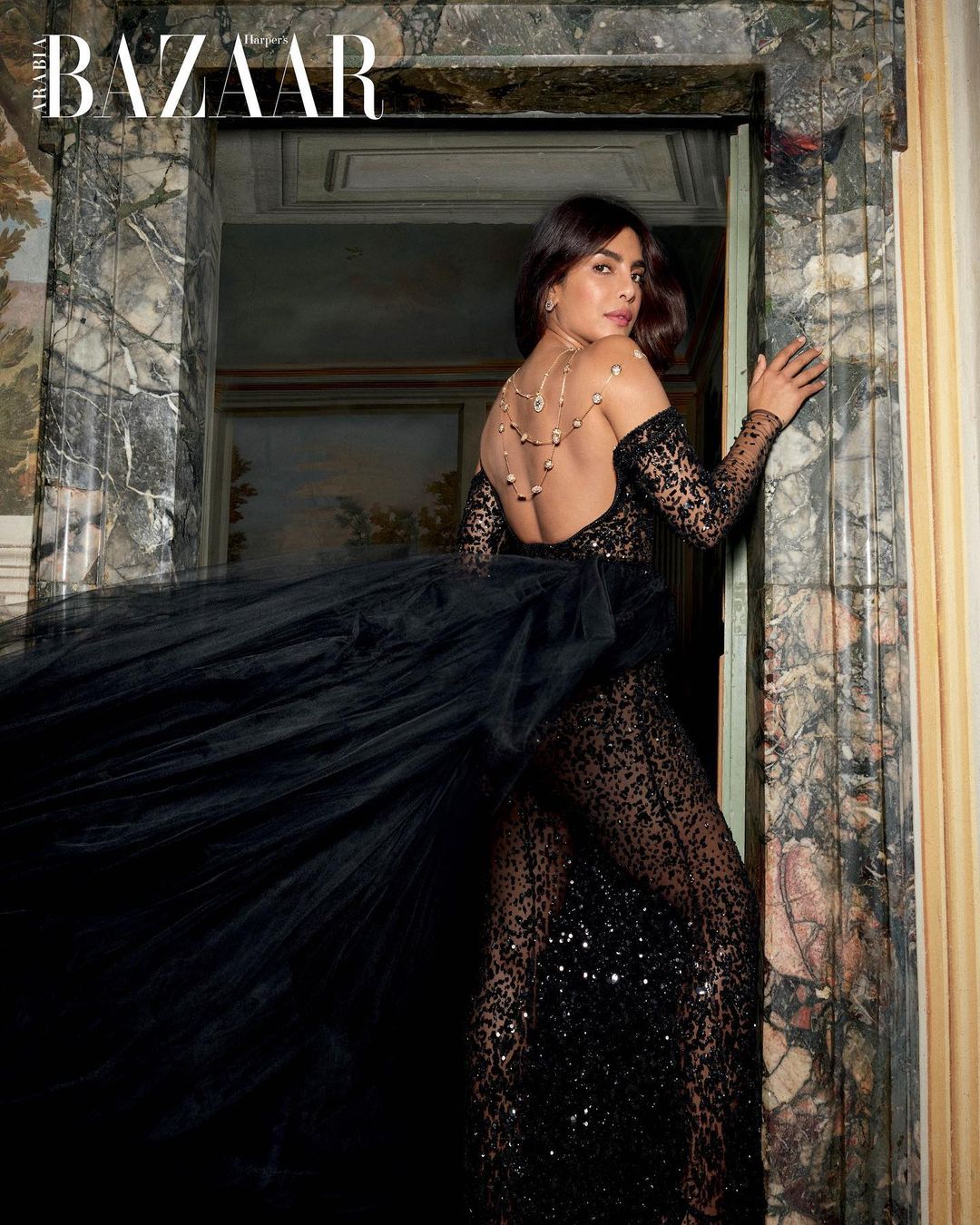 Priyanka Chopra is oozing sexiness in a semi-sheer backless black outfit. 