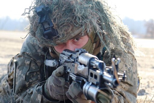 A service member of the Ukrainian Air Assault Forces takes part in tactical drills at a training ground in an unknown location in Ukraine, in this handout picture released on February 18, 2022. (Reuters Photo)