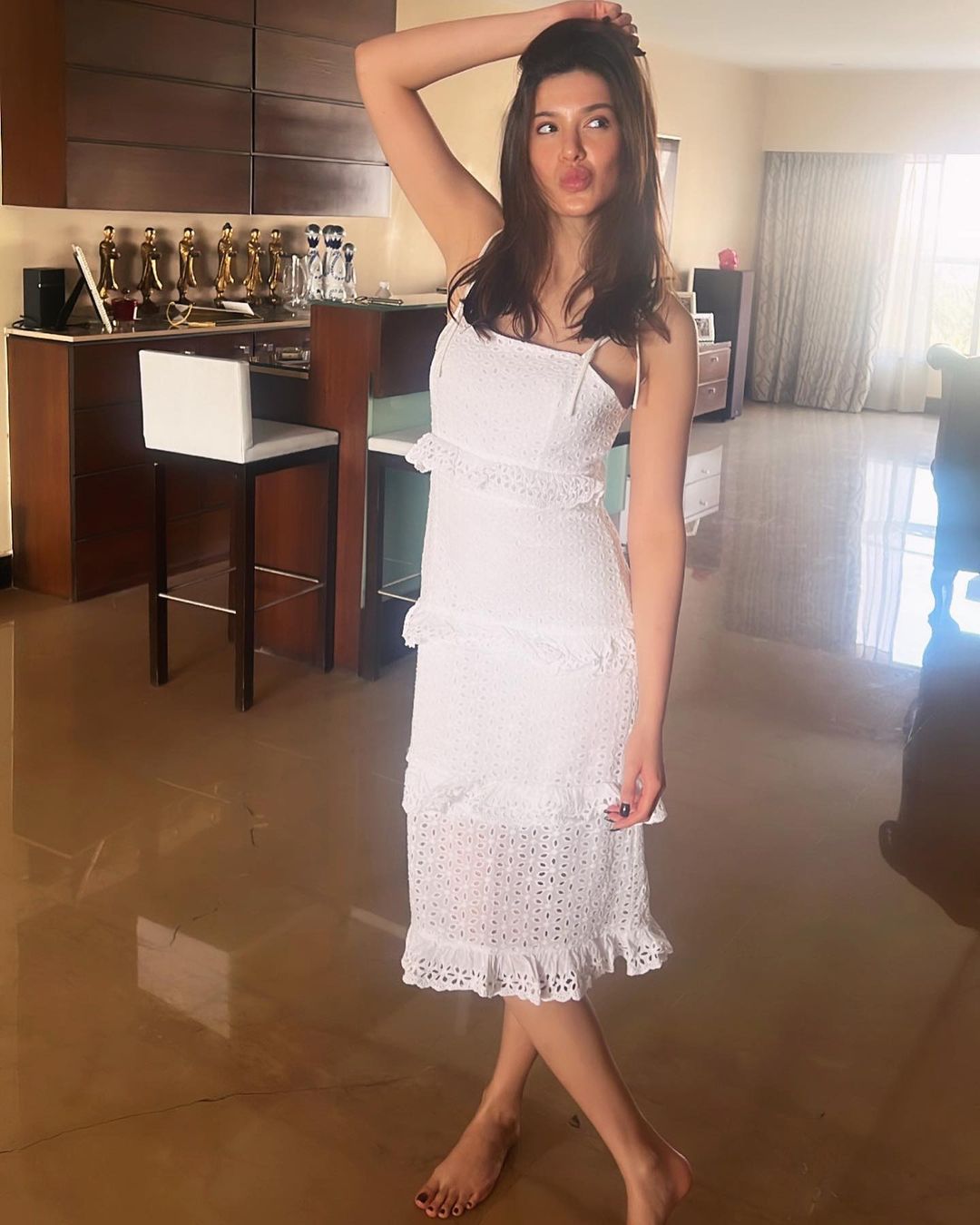 Shanaya Kapoor looks cute in the white midi dress.