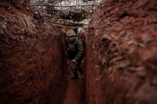 A Ukrainian service member walks along a trench at a position on the front line near the city of Novoluhanske in the Donetsk region, Ukraine. (Image: Reuters)