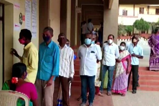 People queue up outside a polling booth in Coimbatore as they await their turn to cast vote for Tamil Nadu Urban Local Body elections. (Image: ANI Twitter)