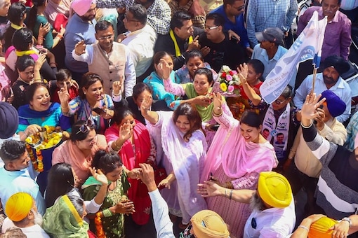 Aam Aadmi Party (AAP) supporters celebrate as the party heads to a landslide victory in the Punjab assembly elections. (PTI Photo)