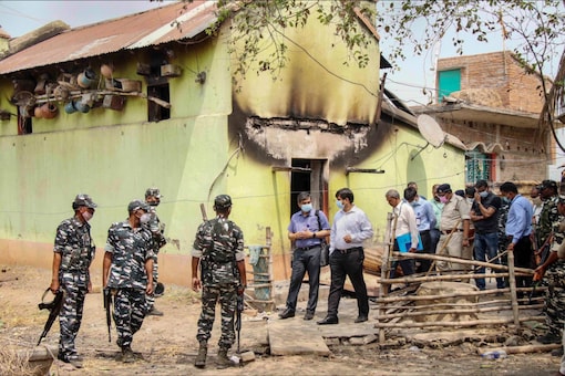 CBI officers with CFSL team investigate near the incident spot at Bogtui village in Birbhum district of West Bengal on March 26, 2022. (PTI Photo)