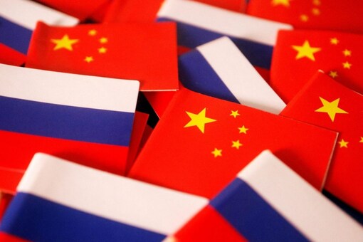 Flags of China and Russia are displayed in this illustration picture taken March 24, 2022. REUTERS/Florence Lo/Illustration
