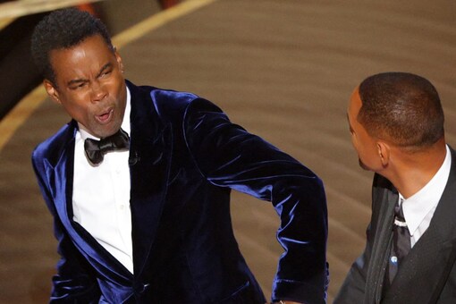 Will Smith (R) hits at Chris Rock as Rock spoke on stage during the 94th Academy Awards. (Photo: Reuters)