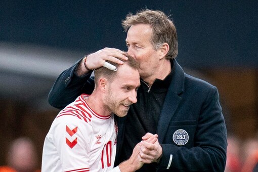 Denmark's Christian Eriksen, left, is substituted and given a hug by National Coach Kasper Hjulman, during the International friendly soccer match between Denmark and Serbia, in the Park, in Copenhagen, Tuesday, March 29, 2022. (Liselotte Sabroe/Ritzau Scanpix via AP)