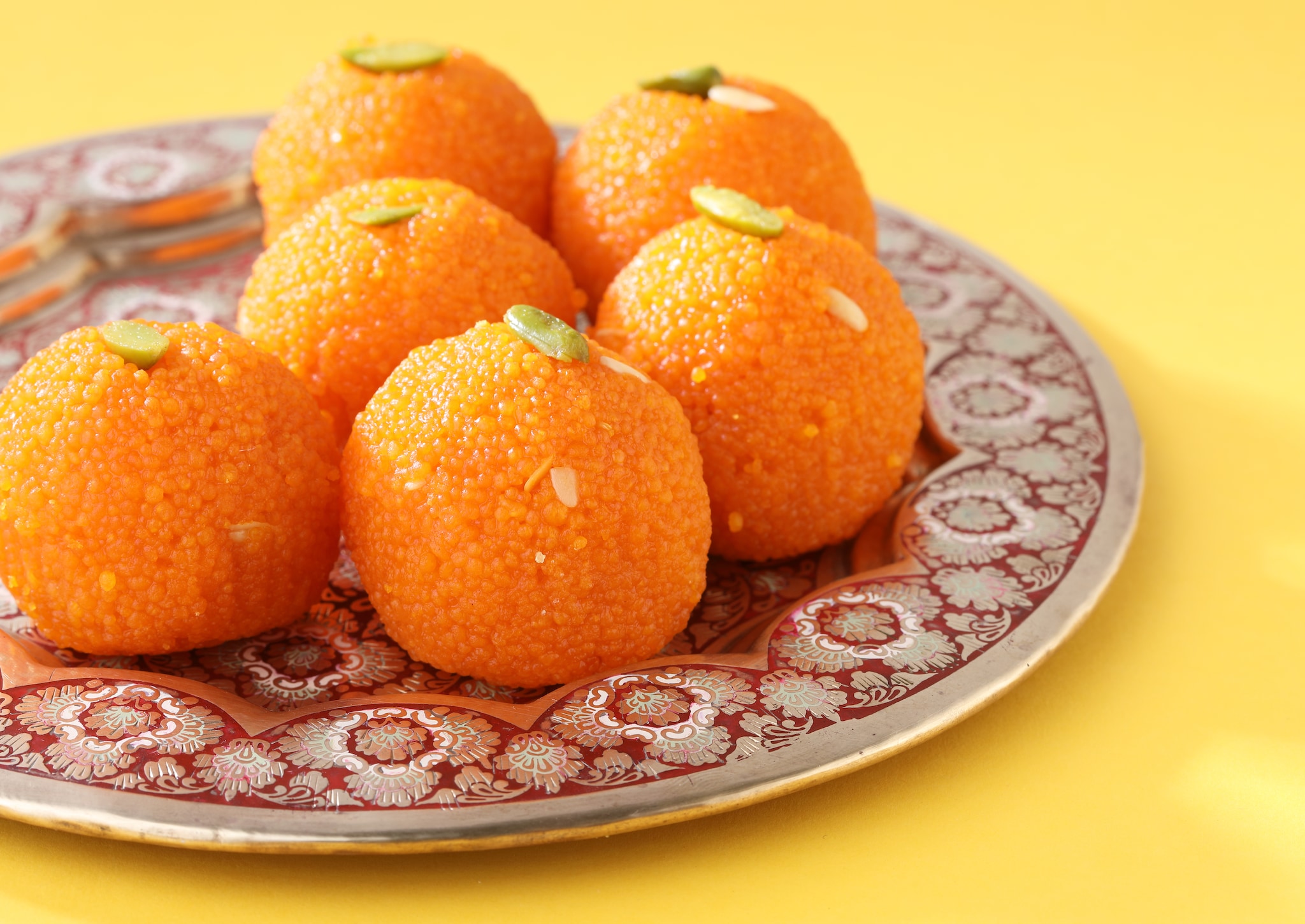 This ball-shaped Indian sweet has lots of variations like- began, motichoor, boondi, and til. (Image: Shutterstock)