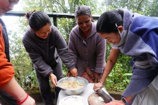 West Bengal Chief Minister Mamata Banerjee rolls dough as she tries her hand at making momos in Darjeeling. (News18)