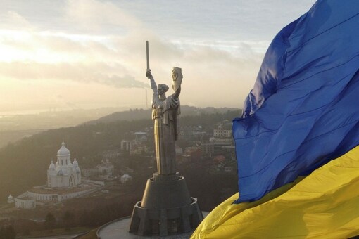 Ukraine's biggest national flag on the country's highest flagpole and the giant 'Motherland' monument are seen at a compound of the World War II museum in Kyiv, Ukraine, December 16, 2021. Picture taken with a drone. REUTERS/Valentyn Ogirenko