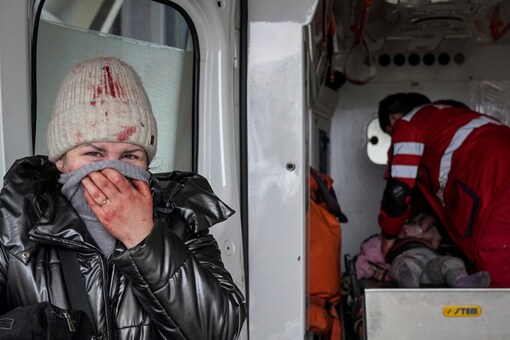 In the background, paramedics are seen attempting to revive the little girl at the back of an ambulance. (Photo: AP)