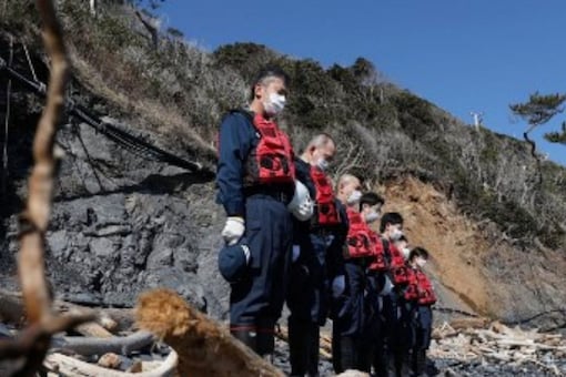 Police officers offer silent prayers to earthquake and tsunami victims in Minamisanriku, Miyagi prefecture on March 10, 2022, one day before the 11th anniversary of the Great East Japan earthquake which triggered a tsunami and devastating nuclear meltdown. (Representational image from AFP)