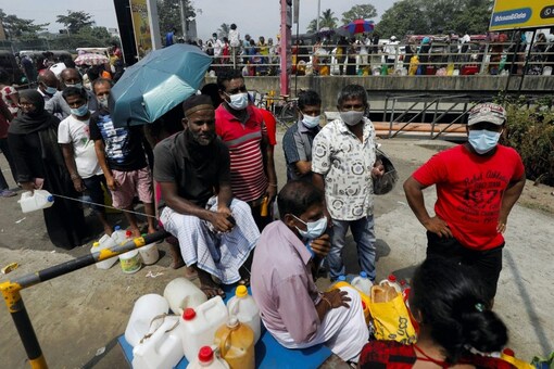 People stand in a long queue to buy kerosene oil due to shortage of domestic gas as a result of economic crisis, at a fuel station in Colombo, Sri Lanka. (Image: REUTERS/Dinuka Liyanawatte)