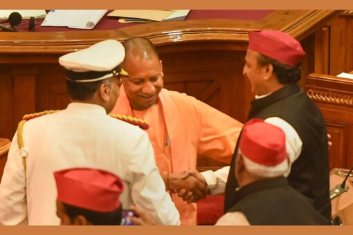 Uttar Pradesh Chief Minister Yogi Adityanath, on Monday, walked across to Leader of Opposition Akhilesh Yadav's seat in the Assembly and greeted him. (PTI Photo)