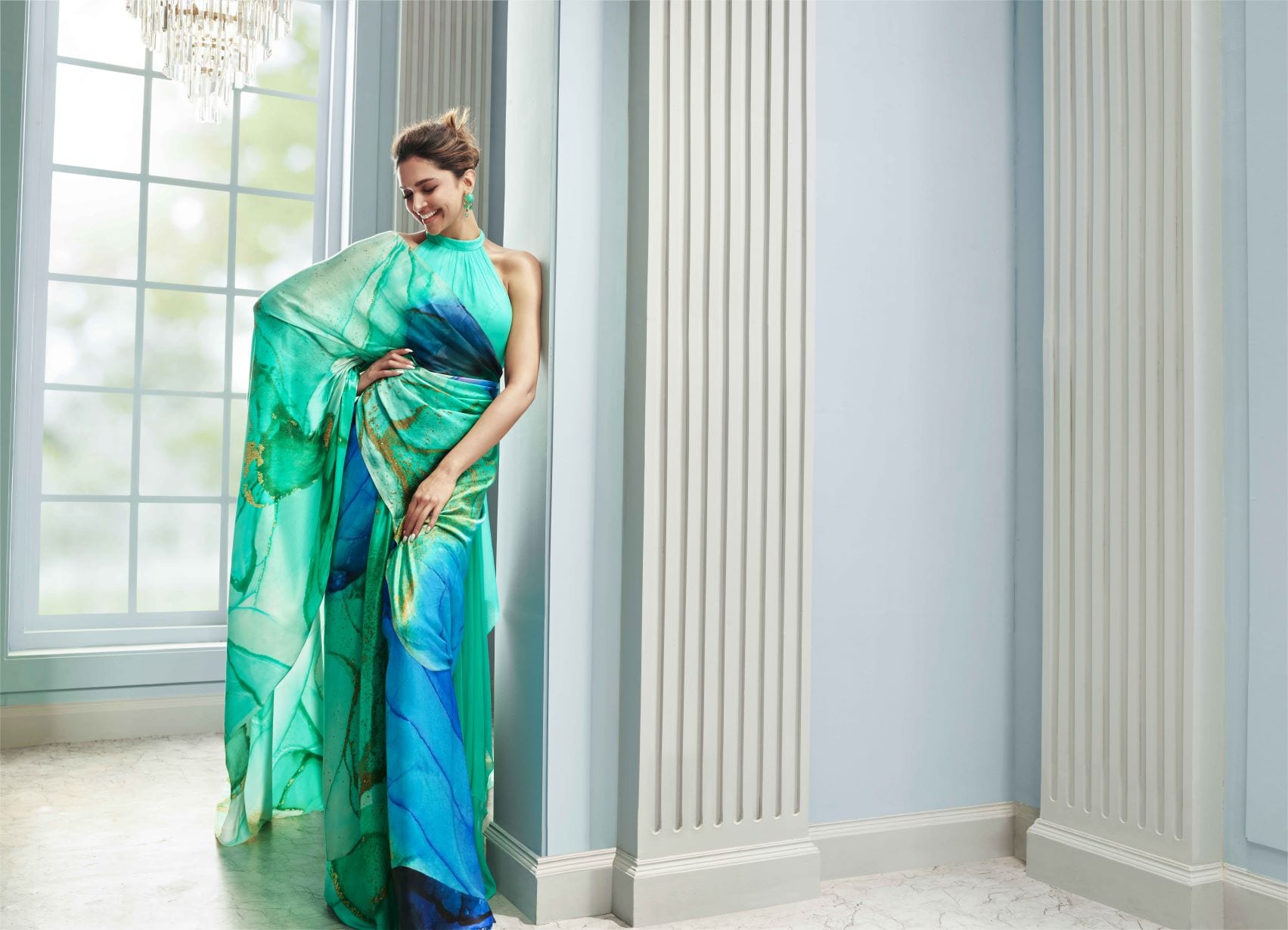 Deepika Padukone stuns in a Liva georgette sari featuring shades of greens and blues.