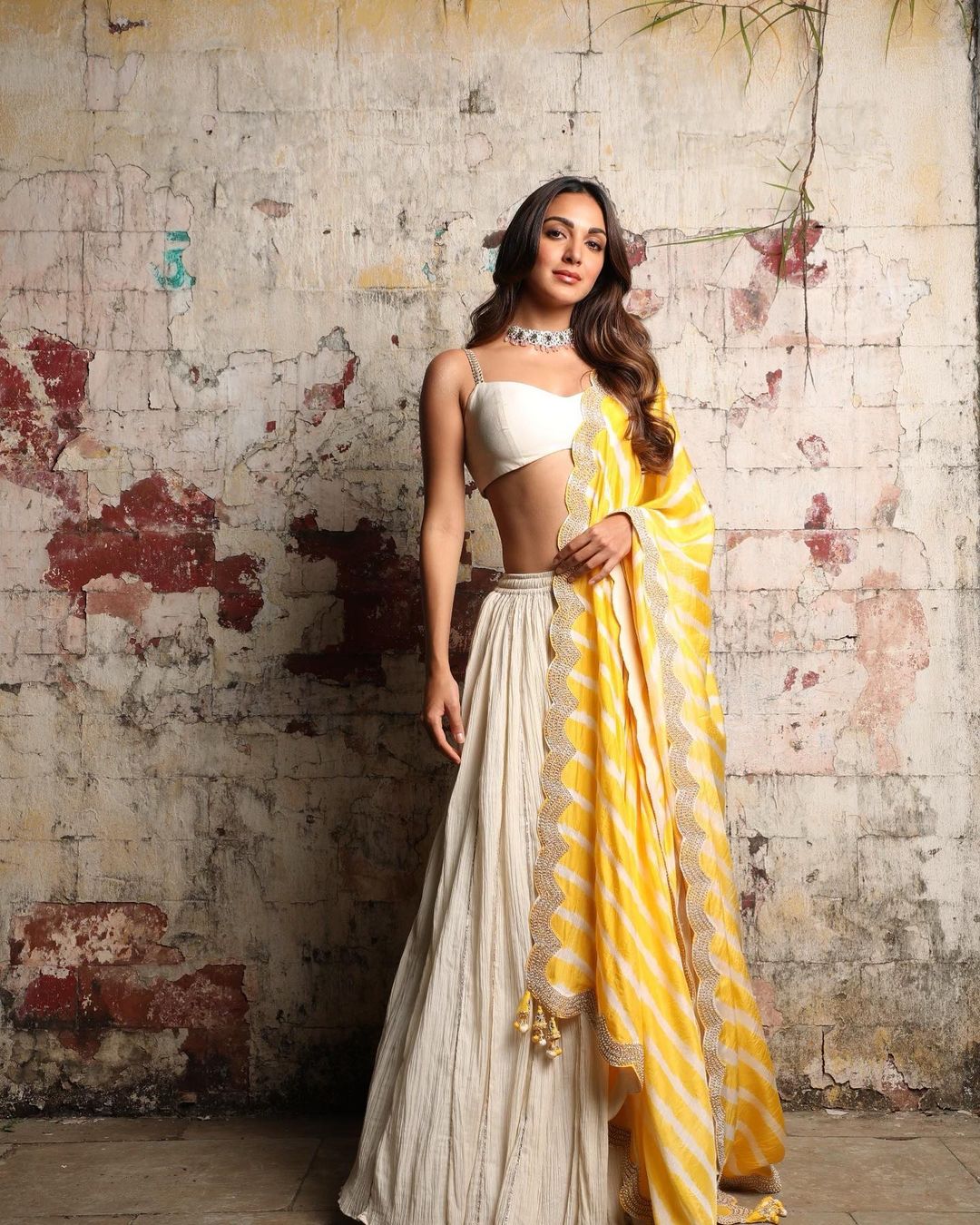 Kiara Advani looks stunning in the white lehenga with the yellow dupatta.