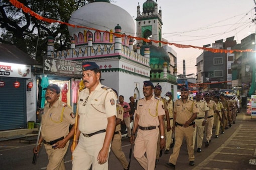 Karad: Police personnel conduct a march ahead of the Eid-ul-Fitr festival, in Karad, Saturday, April 30, 2022. (PTI Photo)