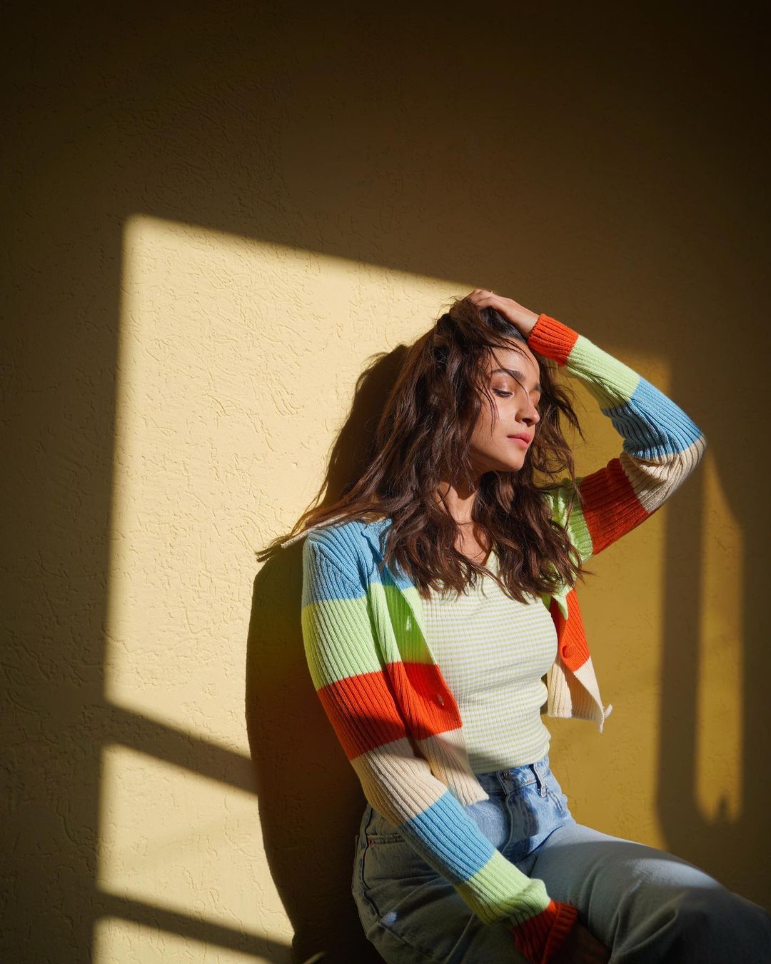 Alia Bhatt looks flawless as she fondles her messy hair out in the sun.