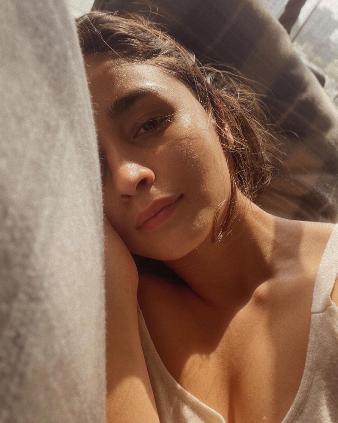 Alia Bhatt looks stunning as she lazes around with the sun on her face. (Image: Instagram) Alia Bhatt looks stunning as she lazes around with the sun on her face.