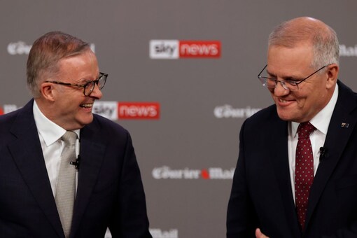 Australian Prime Minister Scott Morrison, right, and leader of the Labour Party Anthony Albanese share a laugh during a debate in Brisbane (Image: AP Photo)