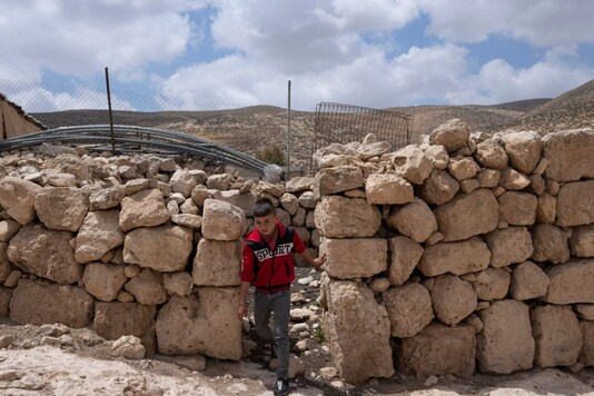 A Palestinian child walks in the West Bank Beduin community of Jinba, Masafer Yatta. Israel's Supreme Court has upheld a long-standing expulsion order against eight Palestinian hamlets in the occupied West Bank, potentially leaving at least 1,000 people homeless. (Image: AP Photo/Nasser Nasser) A Palestinian child walks in the West Bank Beduin community of Jinba, Masafer Yatta. Israel's Supreme Court has upheld a long-standing expulsion order against eight Palestinian hamlets in the occupied West Bank, potentially leaving at least 1,000 people homeless. (Image: AP Photo/Nasser Nasser)