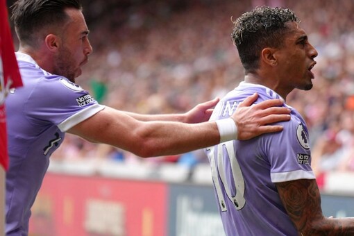 Leeds United's Raphinha, right, celebrates with teammate Jack Harrison after scoring their side's first goal of the game from the penalty spot, during the English Premier League match between Brentford and Leeds United, at the Brentford Community Stadium, in London, Sunday, May 22, 2022. (John Walton/PA via AP)