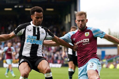 Newcastle United's Jacob Murphy, left, and Burnley's Charlie Taylor battle for the ball during their English Premier League match at Turf Moor, Burnley, England, Sunday, May 22, 2022. (Nick Potts/PA via AP)