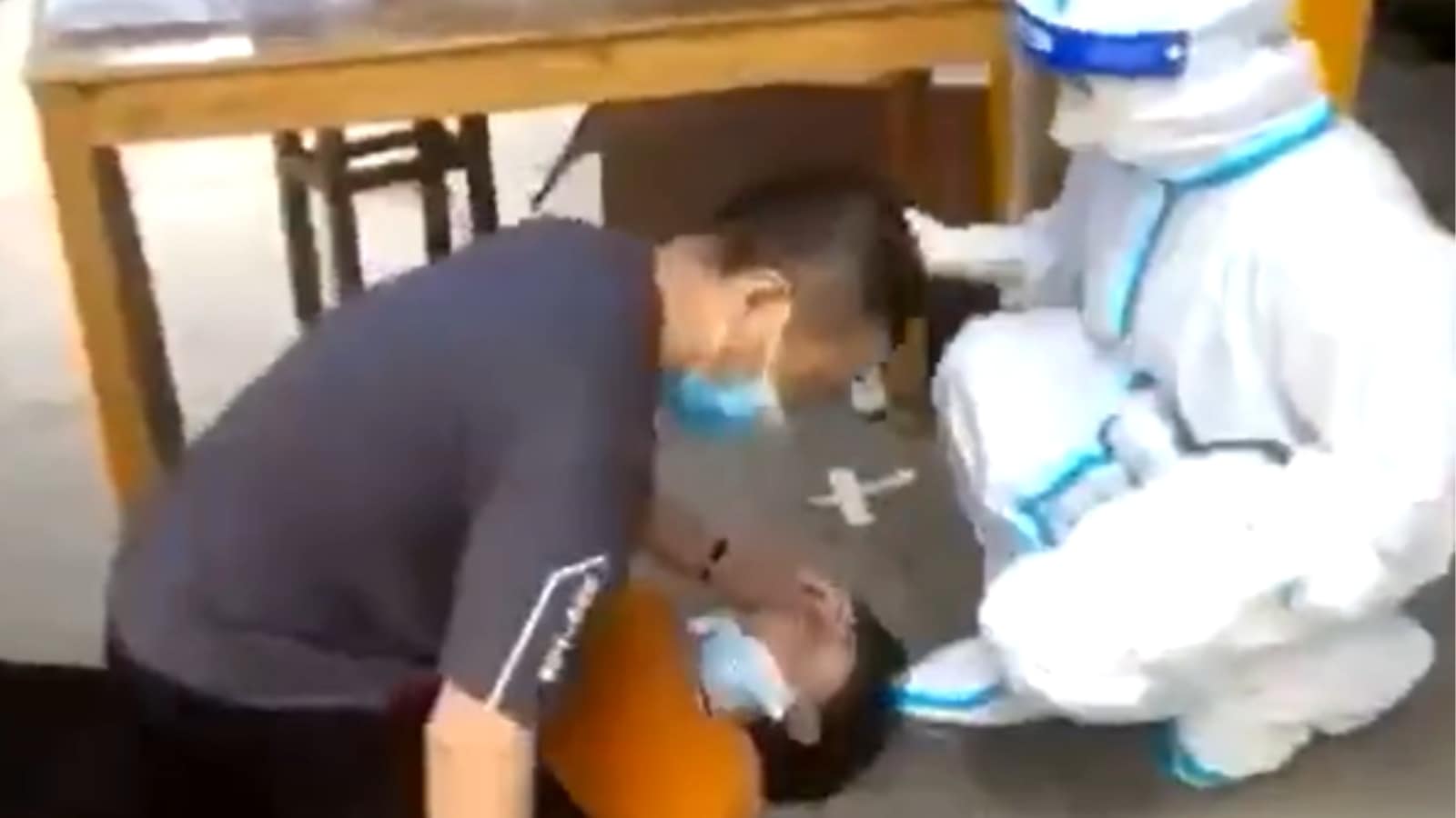 Read more about the article Chinese language Lady Pinned All the way down to Take Forceful Covid-19 Take a look at, Video Is going Viral