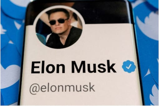 Elon Musk's Twitter profile is seen on a smartphone placed on printed Twitter logos. (Image: Reuters)