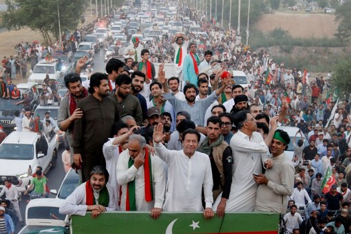 Ousted Pakistani Prime Minister Imran Khan gestures as he travels on a vehicle to lead a protest march in Islamabad, Pakistan. (Reuters)