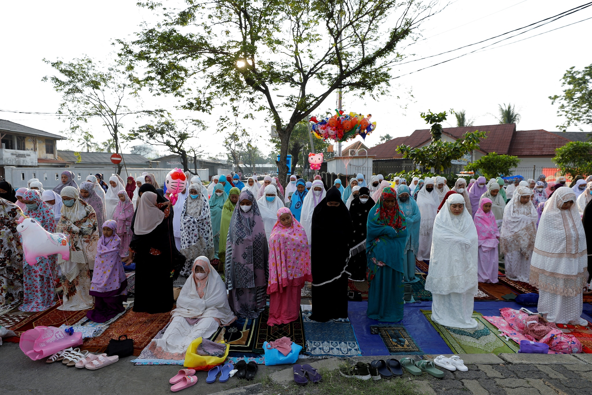 Muslim women attend mass prayers at the Sunda Kelapa port during Eid al-Fitr, marking the end of the holy fasting month of Ramadan, in Jakarta, Indonesia, on Monday. (Image: Reuters)