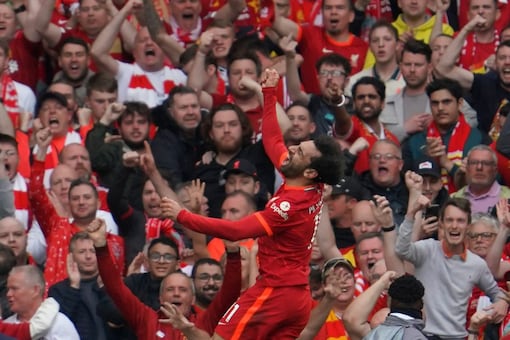 Liverpool's Mohamed Salah celebrates after scoring his goal during the Premier League match between Liverpool and Wolverhampton at Anfield stadium in Liverpool, England, Sunday, May 22, 2022. (AP Photo/Jon Super)