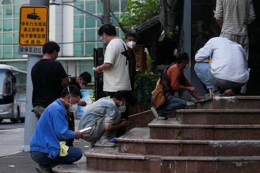 Worker take rapid antigen tests for Covid-19 on the steps of a building during lockdown, amid the coronavirus disease (COVID-19) pandemic, in Shanghai, China (Image: Reuters)
