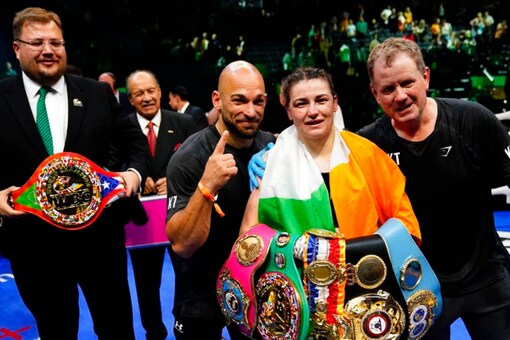 Katie Taylor poses for photographs after winning a lightweight championship boxing match against Amanda Serrano (AP)