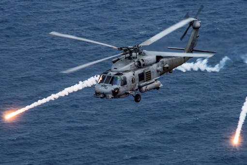 A US Navy MH-60R Sea Hawk helicopter - which Taiwan wants but is deterred from purchasing by the Biden administration - fires chaff flares during a training exercise near the aircraft carrier USS Carl Vinson (CVN 70) in the Philippine Sea. (Image: Reuters)