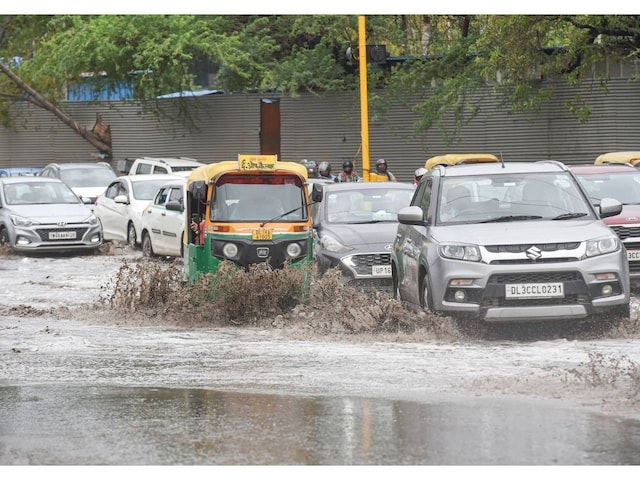 Vehicles move through a waterlogged area following heavy rain, at Lodhi Road in New Delhi. (PTI)
