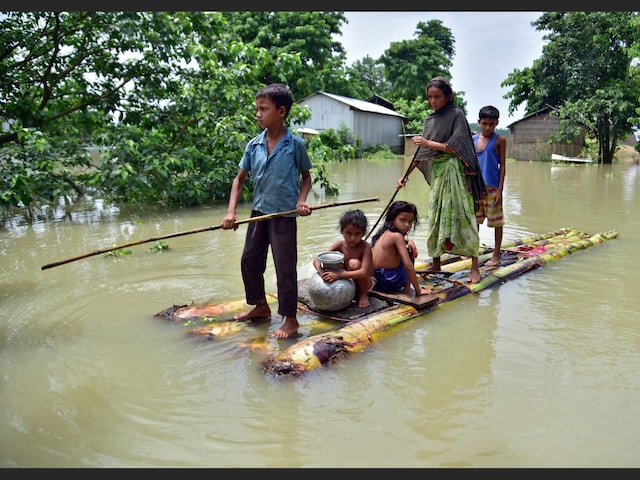 Villagers row a makeshift raft through a flooded field to reach a safer place at the flood-affected Mayong village in Assam's Morigaon district, in June 2020. (File photo: Reuters)