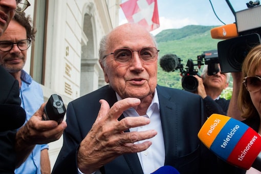Former FIFA president Sepp Blatter is surrounded by the media as he leaves the Swiss Federal Criminal Court in Bellinzona, Switzerland, Wednesday, June 8, 2022. Blatter and former UEFA president Michel Platini have arrived at a Swiss criminal court for their 11-day trial on charges of defrauding FIFA, the world governing body of soccer. (Alessandro Crinari/Keystone via AP)