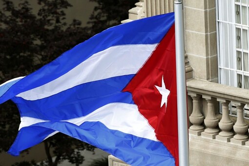 The Cuban flag flutters in the wind after being raised at the Cuban Embassy reopening ceremony in Washington July 20, 2015. REUTERS/Gary Cameron