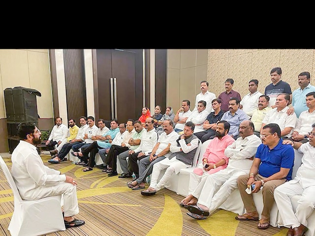 Rebel Shiv Sena leader Eknath Shinde interacts with supporting MLAs at a luxury hotel, in Guwahati on June 23, 2022. (PTI)