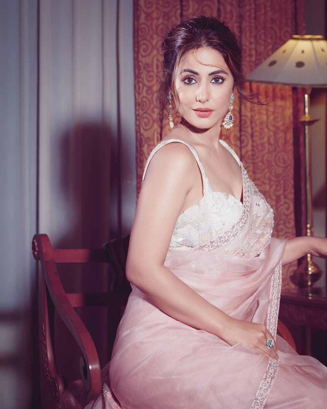 Hina Khan's hair has been styled in a messy bun.