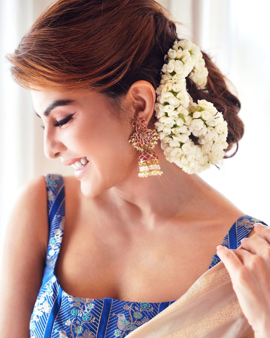 Jacqueline Fernandez stuns with the fresh flowers adorning her hair and traditional jhumkas.