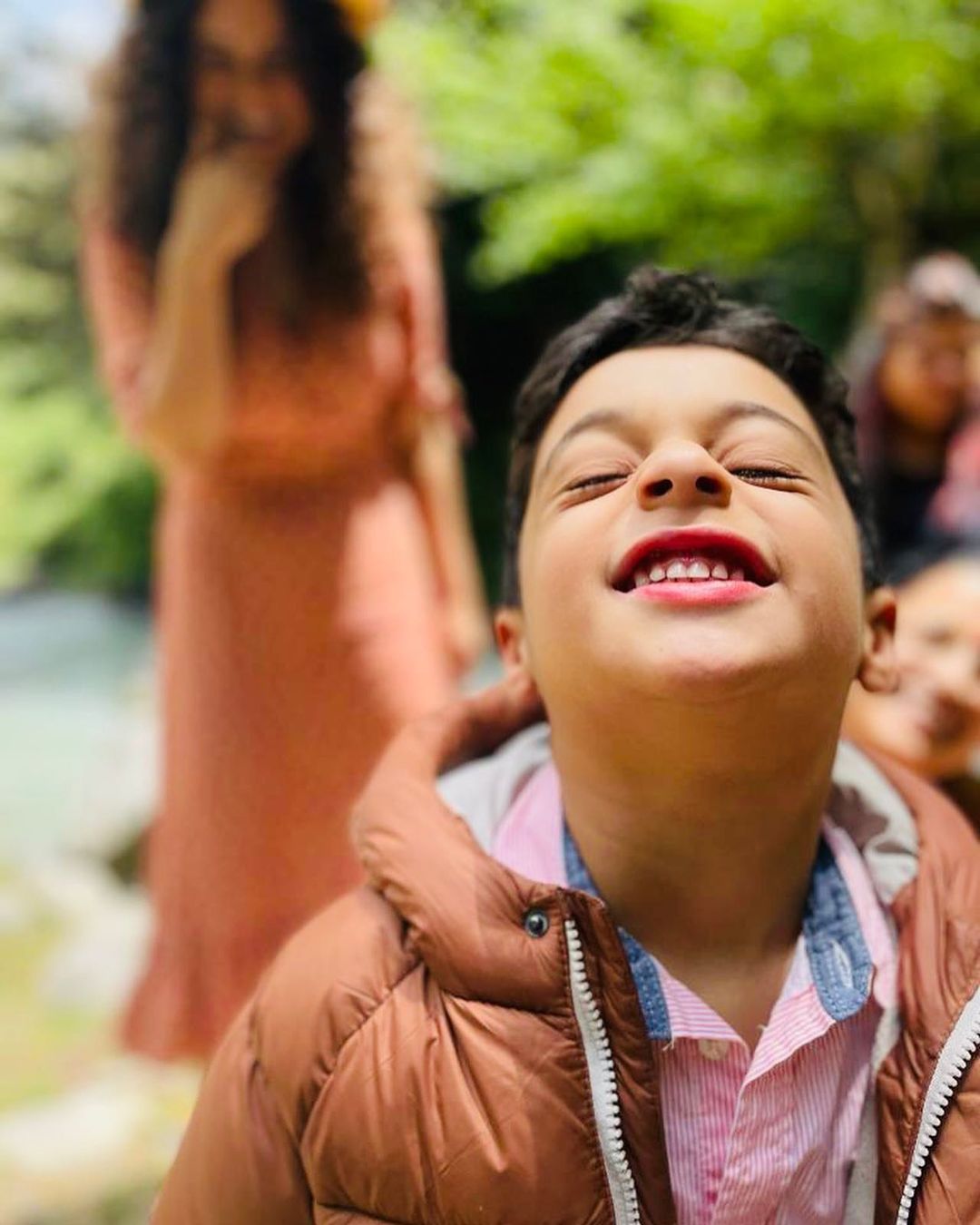 Kangana Ranaut is seen laughing in the background while looking over at her nephew. 
