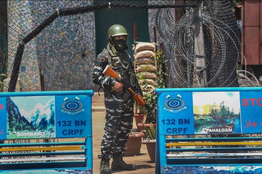 Sources say the camps mainly work as feeders for launch pads in the forward areas. File pic of a CRPF soldier on guard at Srinagar. (PTI Photo/S Irfan)