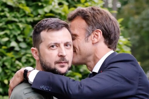 Ukrainian President Volodymyr Zelensky (left) and French Fresident Emmanuel Macron embrace after giving a press conference in Kyiv on Thursday. Photo: Ludovic Marin/AFP
