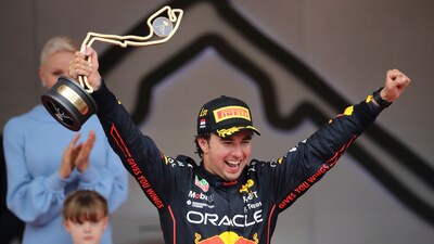 Red Bull driver Sergio Perez celebrates on the podium after winning the Monaco Formula One Grand Prix on May 29, 2022. (AP Photo/Daniel Cole)