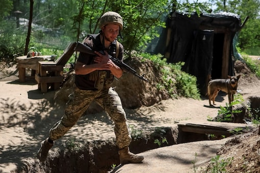 A Ukrainian service member walks at a position on the front line, amid Russia's attack on Ukraine, near the town of New York, Donetsk region, Ukraine (Image: Reuters)