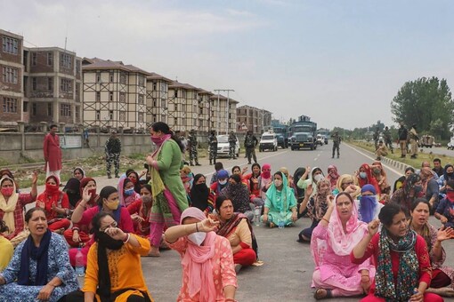 Kashmiri Pandits employed under the PM Package block the Jammu-Srinagar national highway to protest against the killing of the school teacher, Rajni Bala, 36, at Qazigund in Anantnag district, on Tuesday. (PTI Photo)