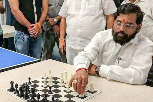 Rebel Shiv Sena leader Eknath Shinde plays a game of chess at a hotel where he is staying with supporting MLAs, in Guwahati. (Image: PTI Photo)