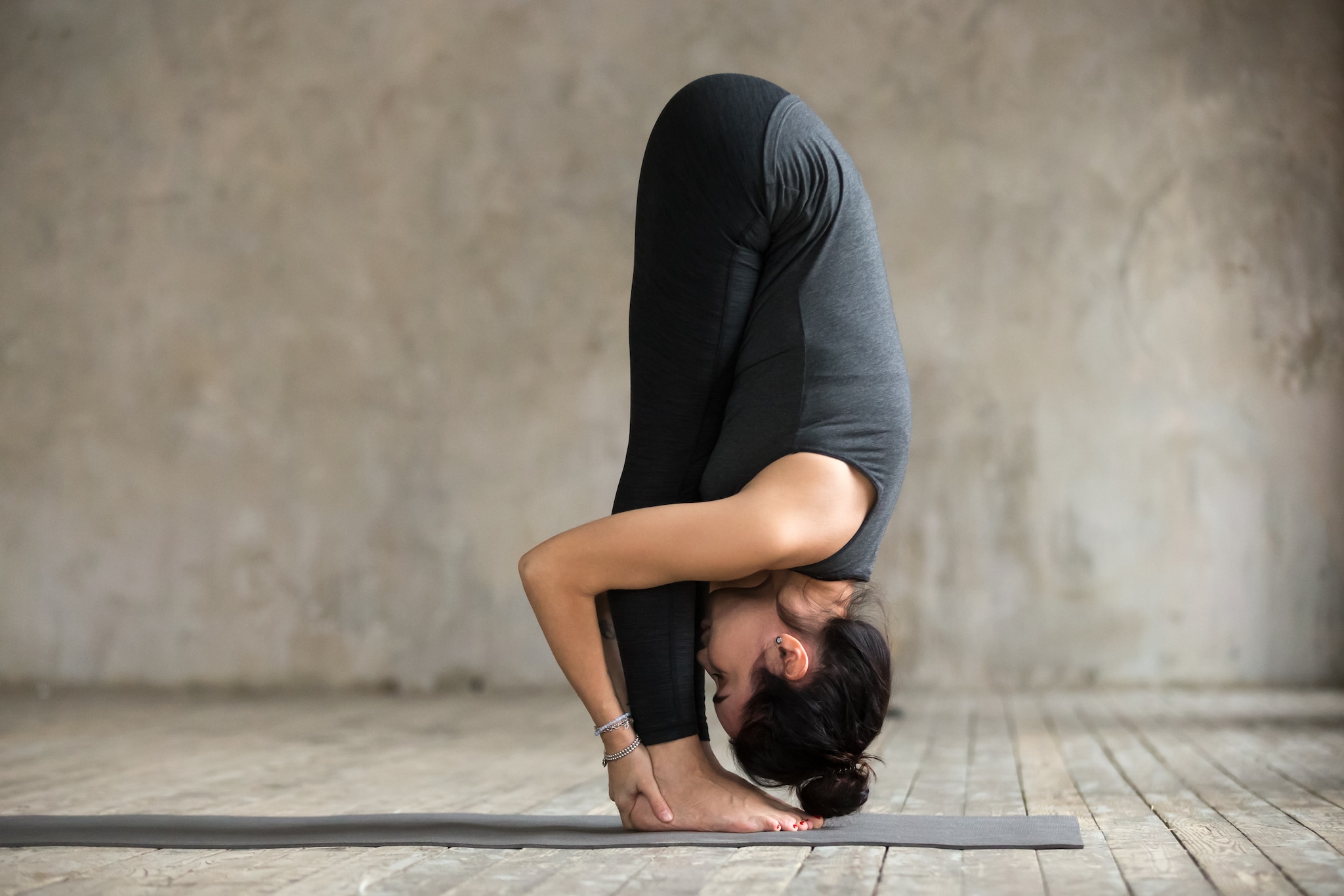 Uttanasana is a great stretching pose that releases tension from your upper body.  (Image: Shutterstock)