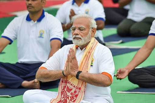 File photo of Prime Minister Narendra Modi while performing yoga at a mass yoga session to celebrate the 8th International Day of Yoga at Mysore Palace. (Image: PTI)